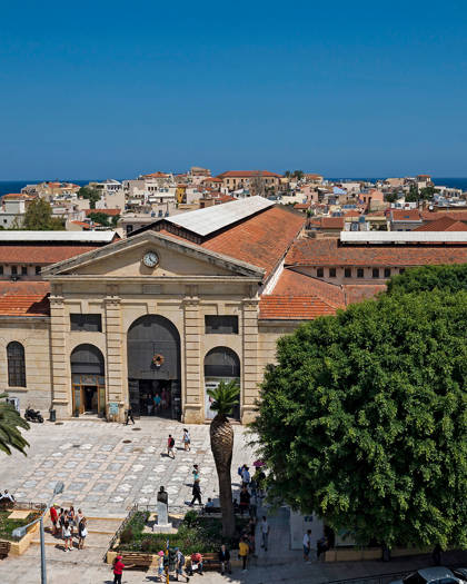 Aerial view of the Municipal Market of Chania, its square and the Old Town rooftops by the sea